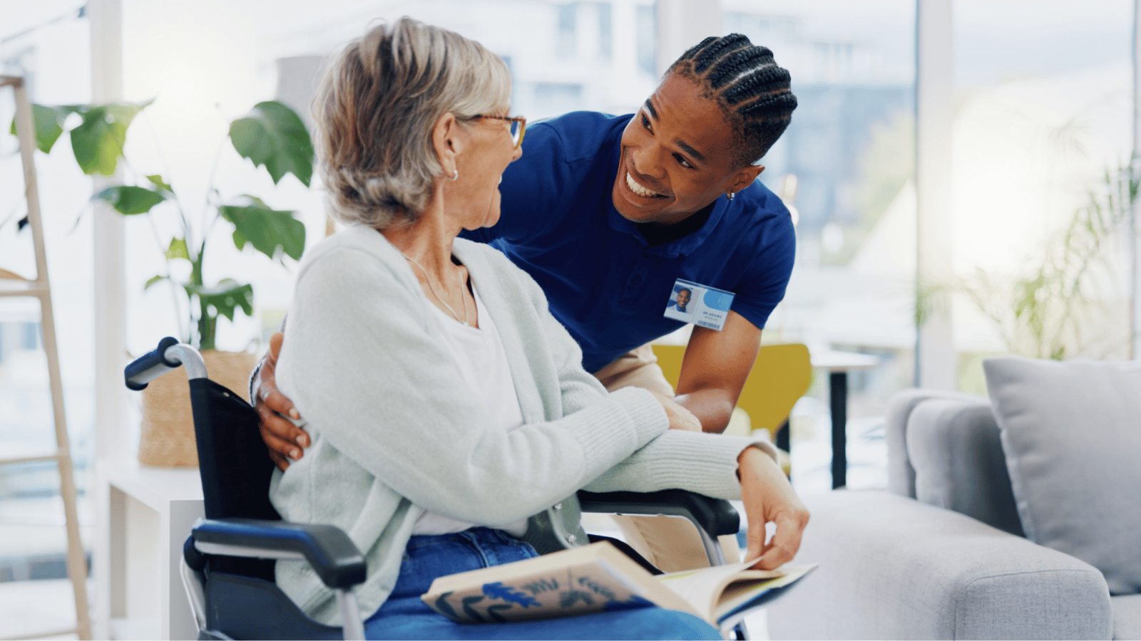 male care taker and elderly woman in a wheelchair